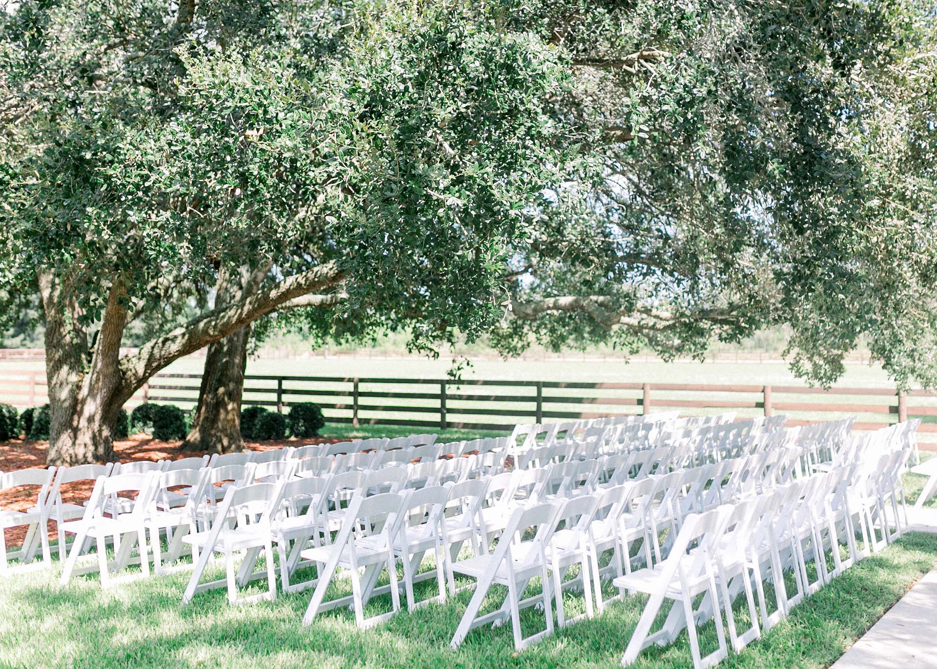 Masters Stables outdoor tree shaded wedding venue chairs-1