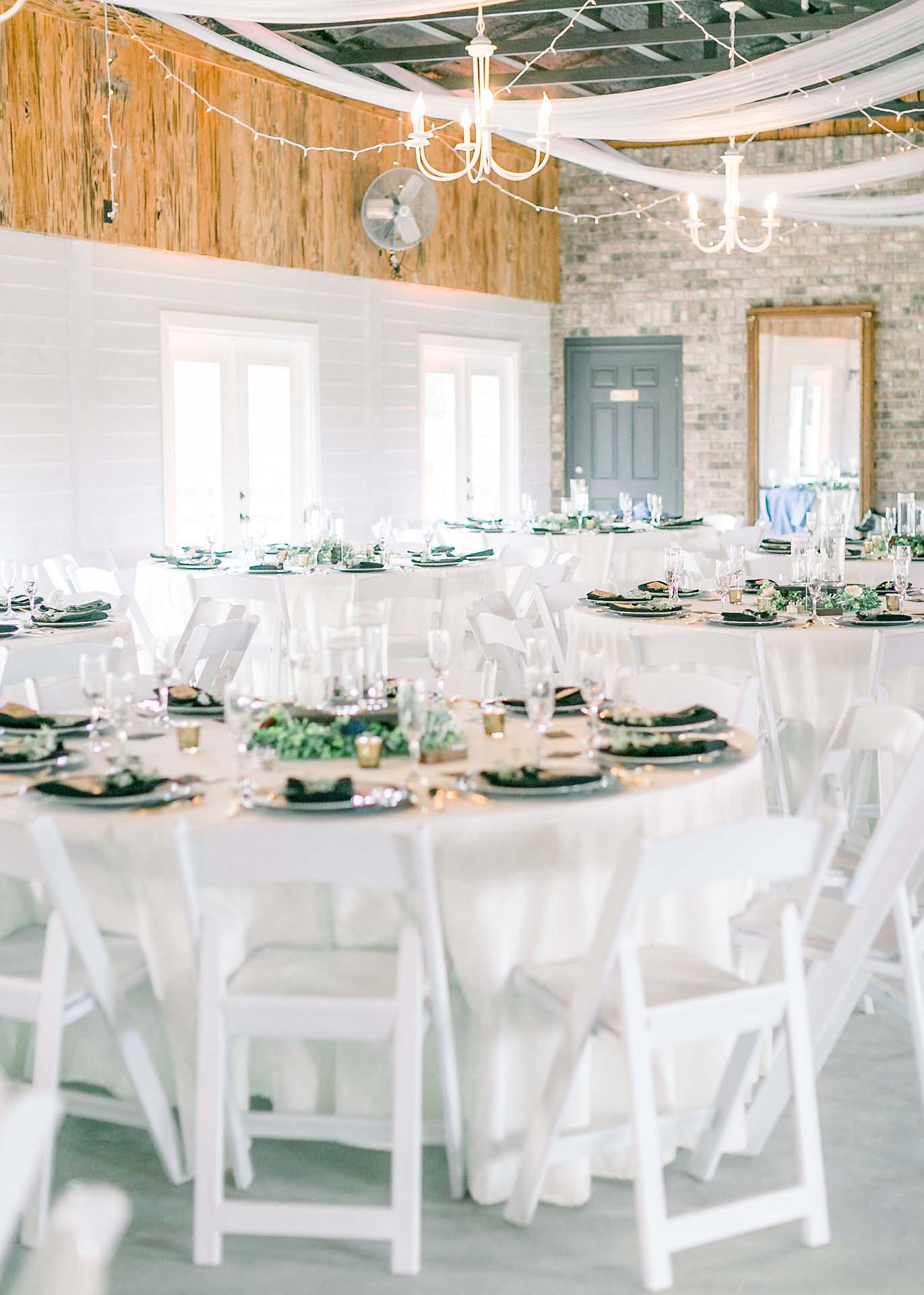 Masters Stables wedding venue air conditioned barn-2 hanging lights tables